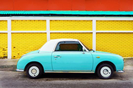 Side view of classic car parked on street in city - vintage retro color effect styles