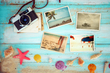 Top view composition - Summer photo album with starfish, shells, coral and items on wooden table....