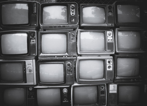 Pattern wall of pile black and white retro television (TV) - vintage filter effect style.