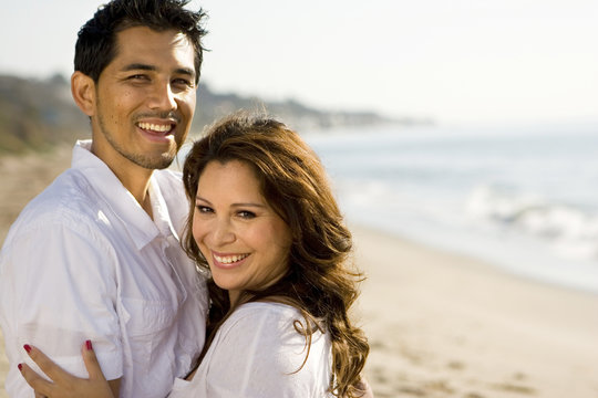Beautiful Hispanic couple laughing and smiling.