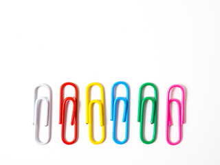 Colorful paperclips on white background