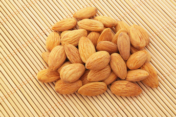 Almonds on bamboo background