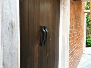 Wooden door in brick wall