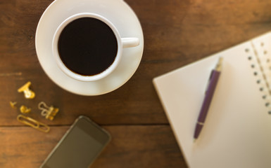 Hot cup of coffee on wooden work table