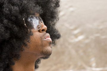 African American man with an Afro wearing sunglasses.