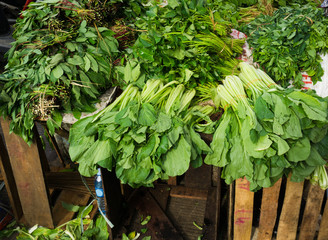 Various kind of green vegetables sold at Bogor traditional market photo taken in Indonesia