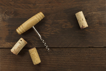 Fototapeta na wymiar Photo of wine corkscrew and corks on dark background
