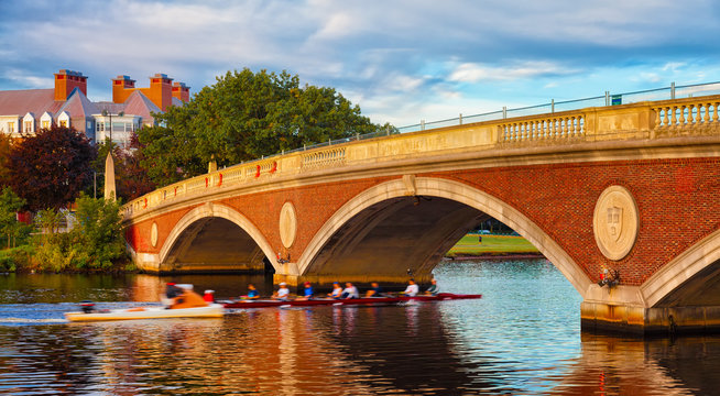 Harvard University scull team rowing practice. Motion blur going under bridge.