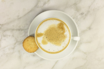 Cup of coffee with milk and butter cookie