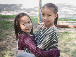 Cute Asian child playing in a park.