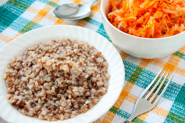 Buckwheat porridge and carrot salad on the table