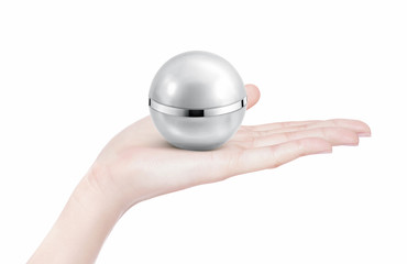Fototapeta na wymiar Silver sphere cosmetic jar on hand isolated
