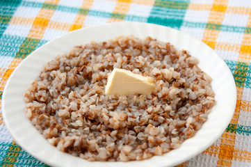 Buckwheat porridge with butter on a slice of breakfast
