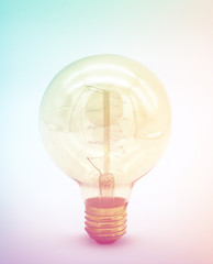 Incandescent lighted bulb with filaments and background