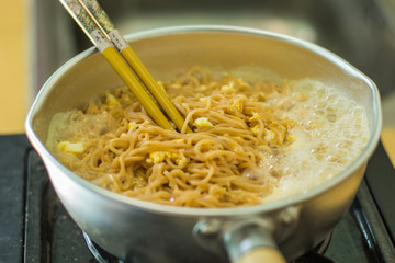 Noodles in a pan with hot food.