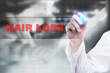 Medical doctor drawing hair loss on virtual screen.