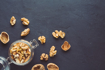 Walnuts in a jar on a dark background