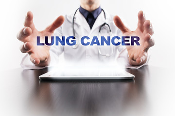 Medical doctor using tablet PC with lung cancer medical concept.