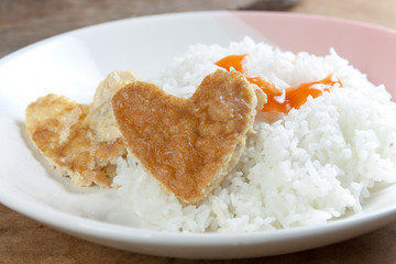 Heart shaped omelet and rice in white dish