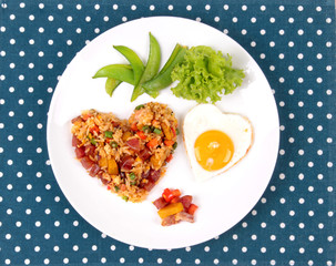 Chinese sausage fried rice and sunny egg in heart shapes.