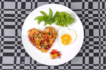 Chinese sausage fried rice and sunny egg in heart shapes.