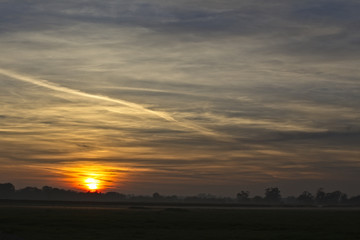 Sunset over farmland, Gloucestershire, England, UK.
