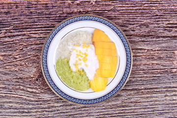 Ripe golden mango with green and white of sticky rice.