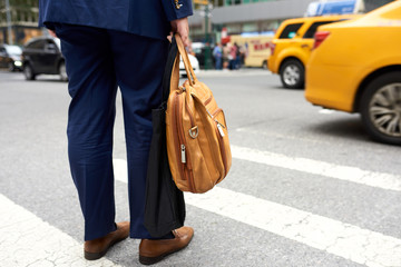 Businessman waiting for yellow cab on the street in Manhattan, New York