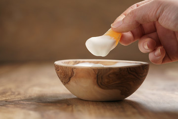 eating organic yogurt with tangerine from wood bowl, shallow focus