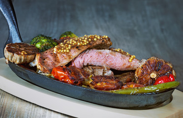 Beef tenderloin with blood on the grill with vegetables