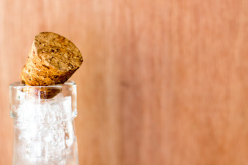 Cold ice bottle on blur wood background or backdrop