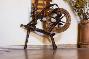 Traditional devices, vintage tailoring equipment concept. Old fashioned wooden distaff, spindle, spinning wheel