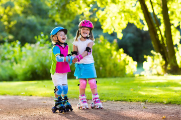 Kids roller skating in summer park