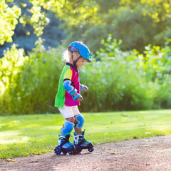 Kids roller skating in summer park