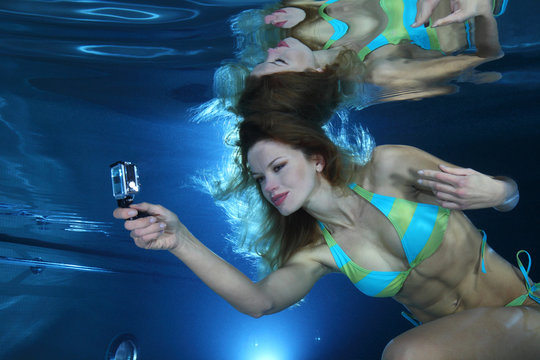 Female swimmer with camera