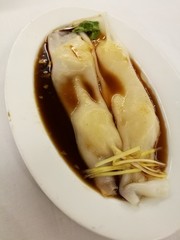 Chinese food in China town, steam warp noodle stuff with prawn in soy sauce, dim sum bamboo tray, steam ho fun noodles, in the local traditional Chinese restaurant with blur background table