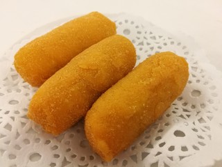 Chinese food in China town, Sweet cream custard deep fried on white plate in the local traditional chinese restaurant with blur background table, closed up