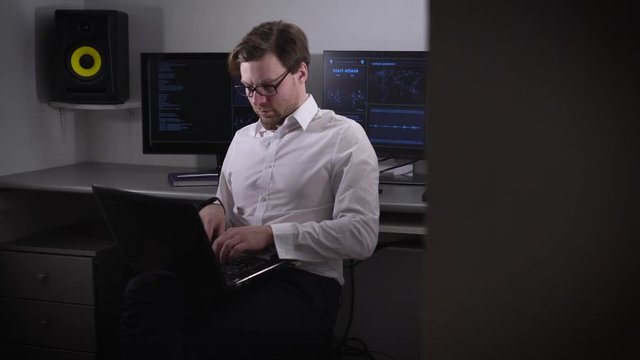The programmer prepares for setup of the equipment in the computer room. The person at bystry speed enters into information in the laptop. The computer room is equipped with the best technology.