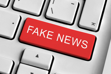 White keyboard with red Fake news button
