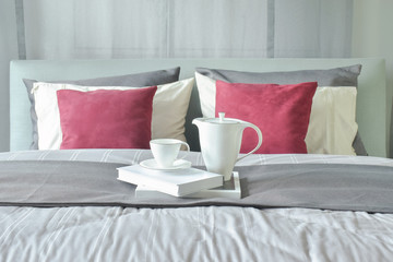 Tea cup and jar setting with books on modern classic style bedding decoration