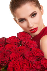 Fototapeta na wymiar Beautiful model posing with red roses in the studio. Valentines