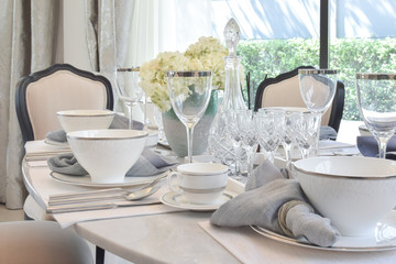 elegant table set on marble dining table in vintage style dining room interior