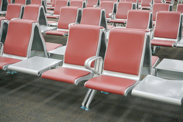 row of red seats at airport terminal