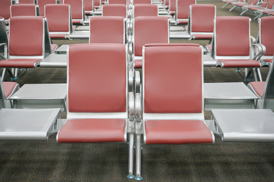 row of red seats at airport terminal