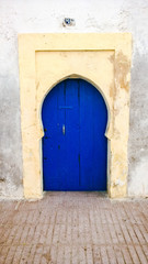Fototapeta na wymiar Simple traditional blue Moroccan door, Essaouira, Morocco
