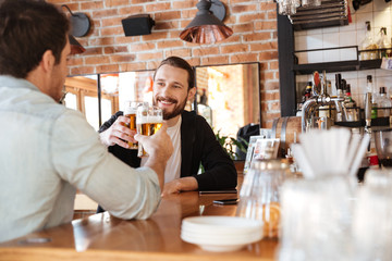Photo from back of man with friend drinking beer