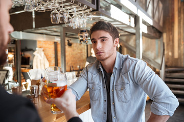 Cropped image of man with his friend drinking beer