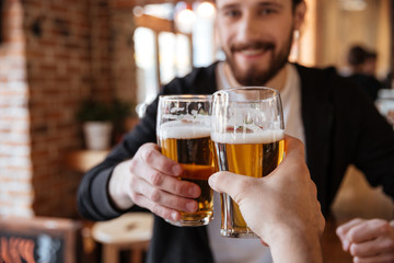 First view of man clinking glasses with friend