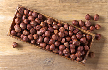 Hazelnuts in old wooden dish
