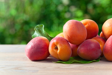 Fototapeta na wymiar juicy ripe apricots on table in garden
